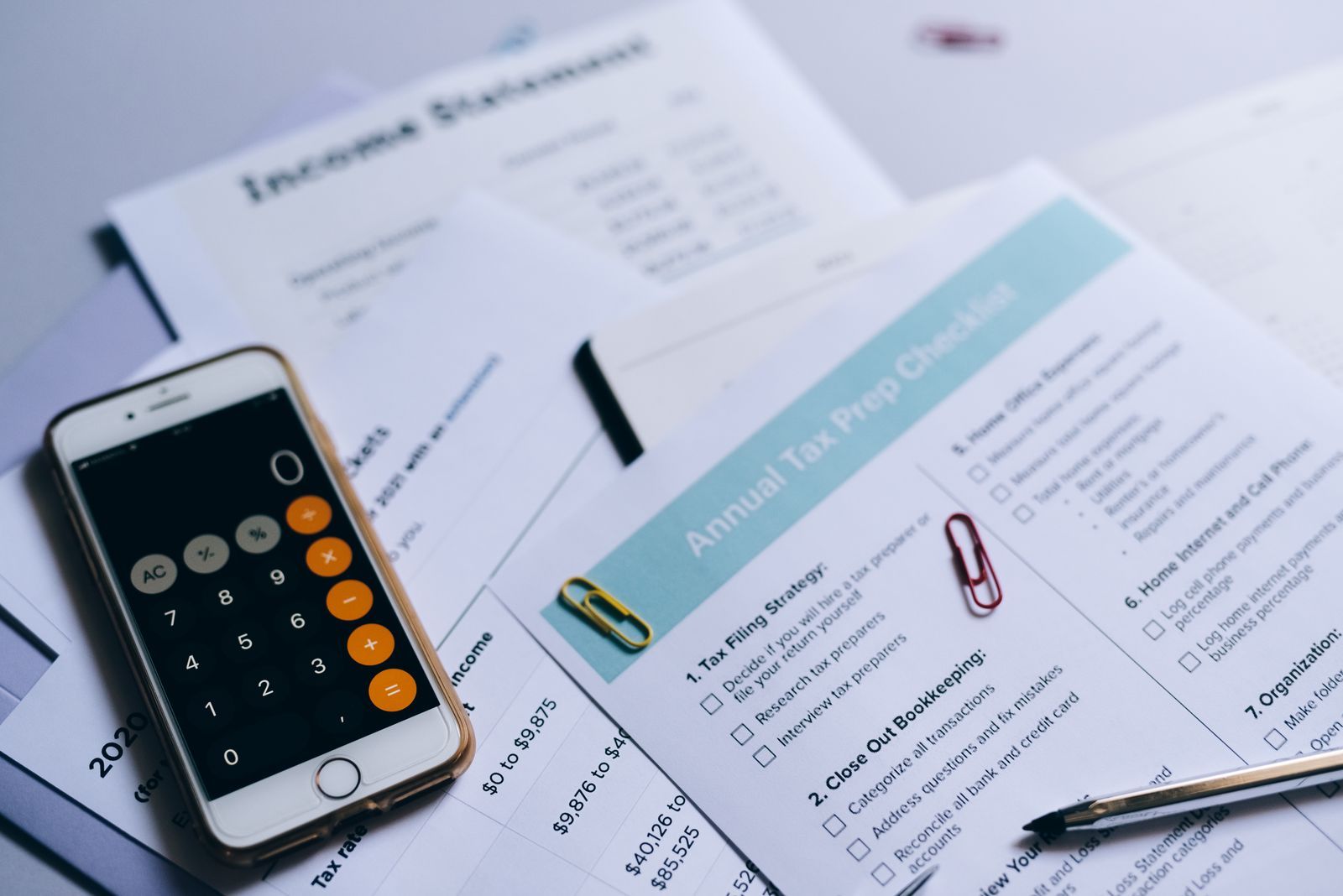 Tax preparation checklist and documents on a desk